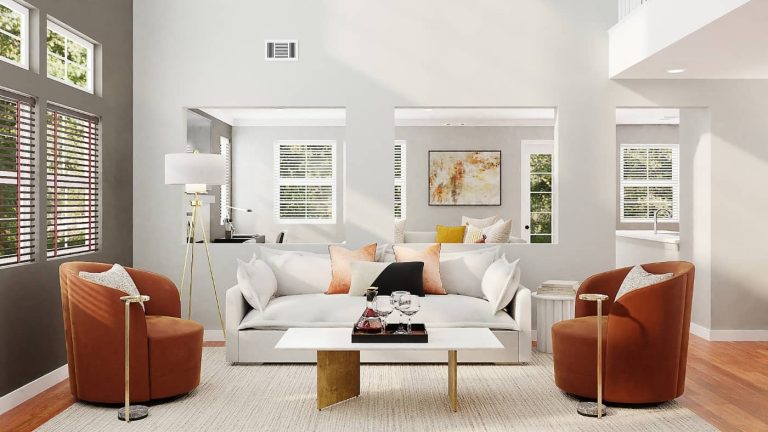 Sala luminosa con un sofá blanco y sillones naranjas