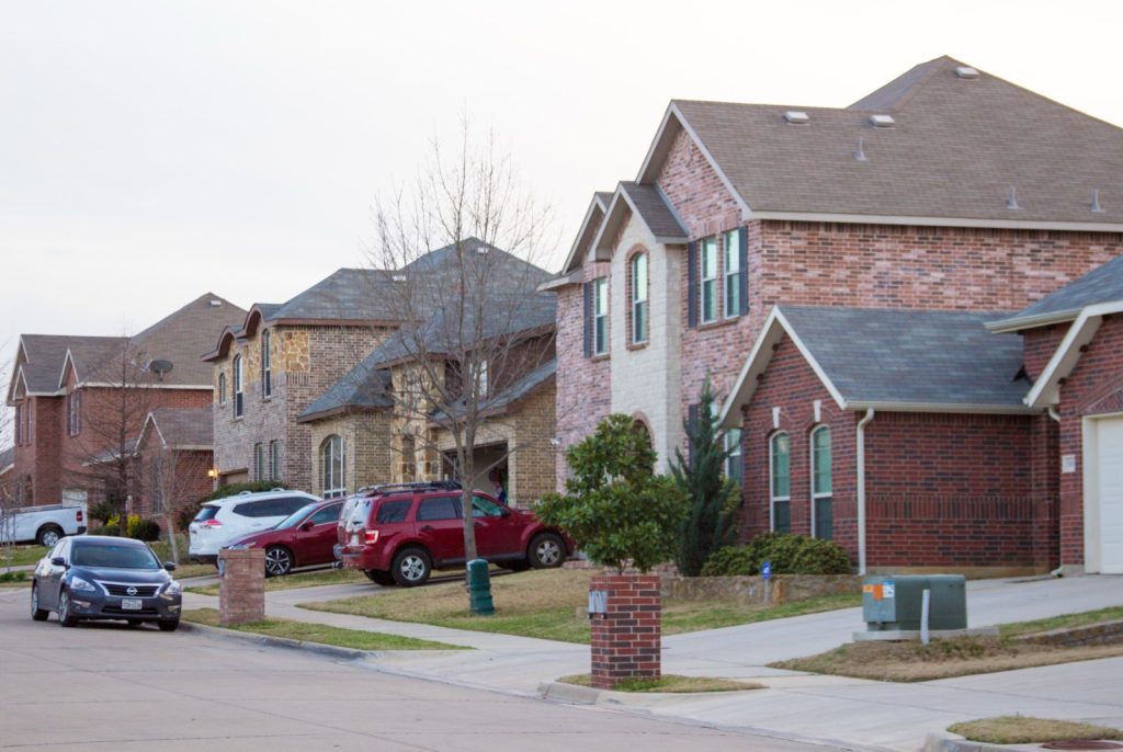 Suburban street lined with brick homes