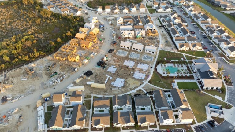 Aerial view of new homes under construction in a planned community